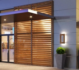 Low-Profile Architectural Wall Light with Backlit and Center Panel Illumination for Facade Enhancement