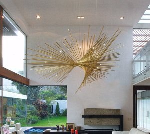 Celestial Chandelier Light with Brass Rods and Pinpoint LED Bulbs Creating a Starry Night Effect