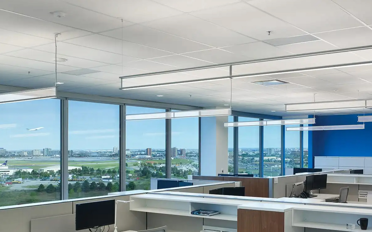 Suspended Linear LED Fixture with Transparent Vertical Anidolic Optics